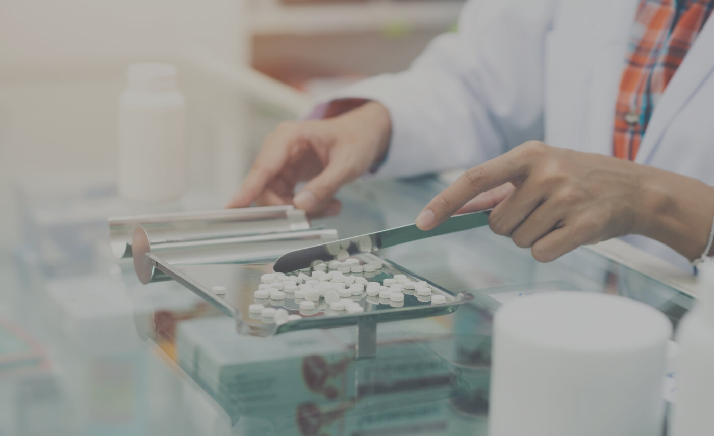 Pharmacist counting pills